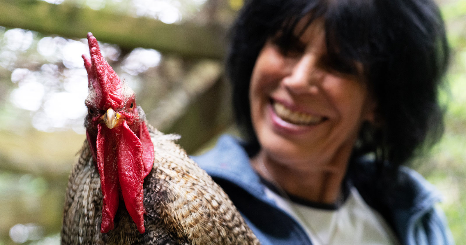 Rainbow looking into the camera. Karen smiling and looking at Rainbow