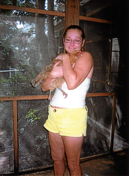 Debbie Alekna hugs her hen Nella